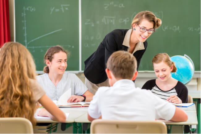 Middle school teacher assigns group work to her public charter school students.